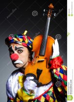 sad-clown-performing-vioin-33225593.jpg