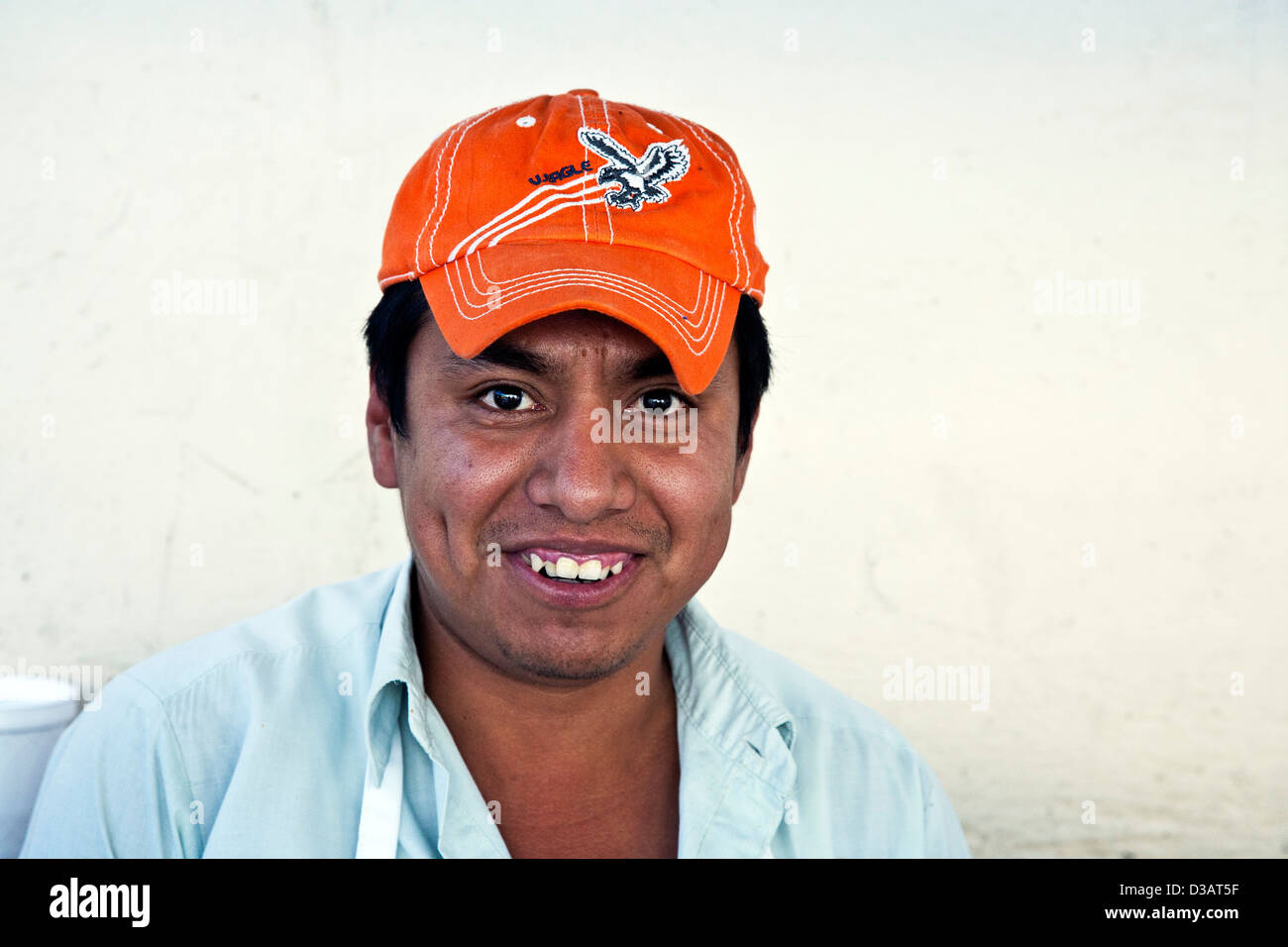 happy-smiling-young-mexican-man-street-vendor-wearing-orange-baseball-D3AT5F.jpg