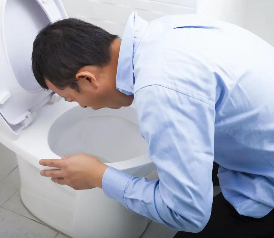 man-in-blue-shirt-hunched-over-toilet.jpg
