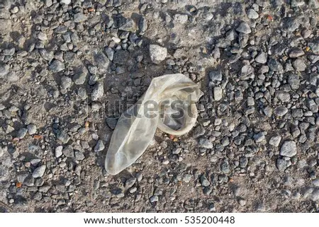 stock-photo-used-condom-on-ground-535200448.jpg
